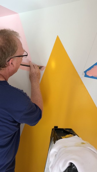 Barney painting crisp shapes on a wall